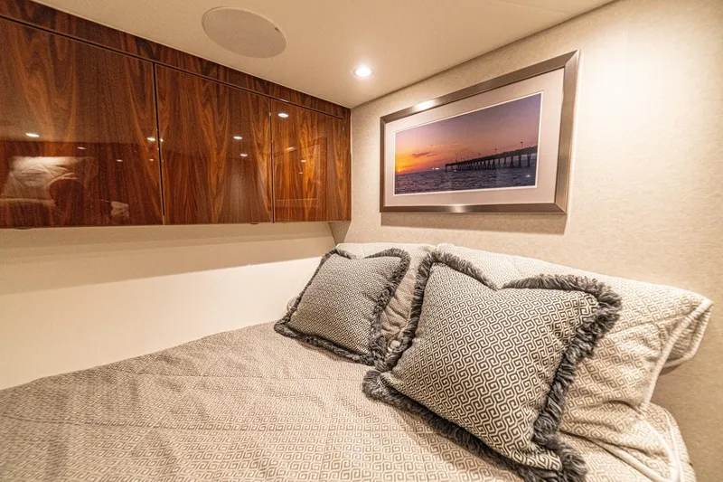 El Lobo Yacht Photos Pics Luxurious cabin interior of 2020 Viking 58 Convertible yacht with elegant bedding and artwork.