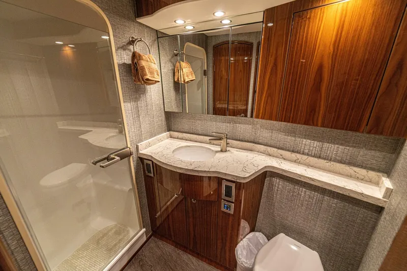 El Lobo Yacht Photos Pics Luxurious bathroom in 2020 Viking 58 Convertible yacht with marble countertop and wooden cabinetry.