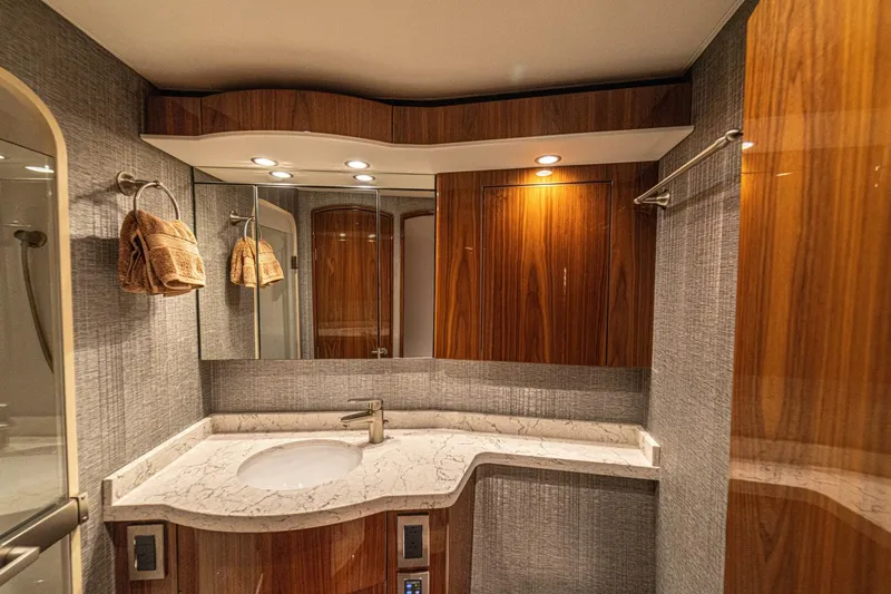 El Lobo Yacht Photos Pics Luxurious bathroom in 2020 Viking 58 Convertible yacht with elegant wood and marble finishes.