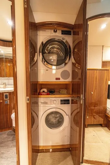El Lobo Yacht Photos Pics Laundry area inside 2020 Viking 58 Convertible yacht with stacked washer and dryer.