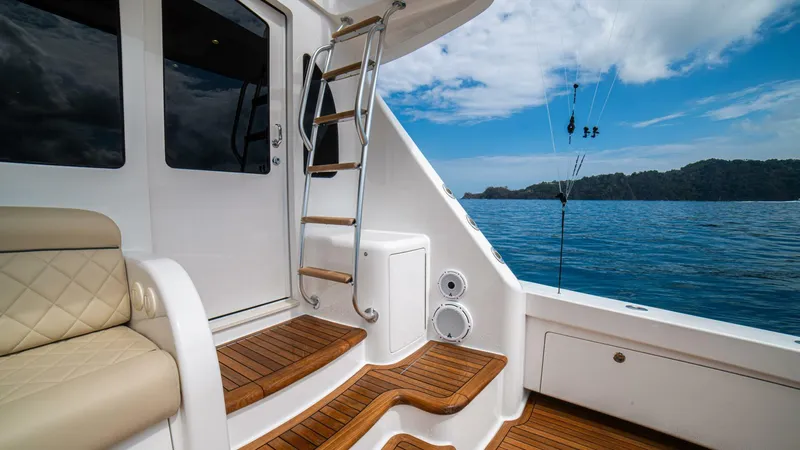 El Lobo Yacht Photos Pics Luxurious 2020 Viking 58 Convertible yacht interior with ocean view and elegant wooden steps.