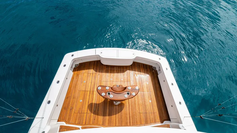 El Lobo Yacht Photos Pics 2020 Viking 58 Convertible yacht deck with teak flooring, surrounded by blue ocean water.