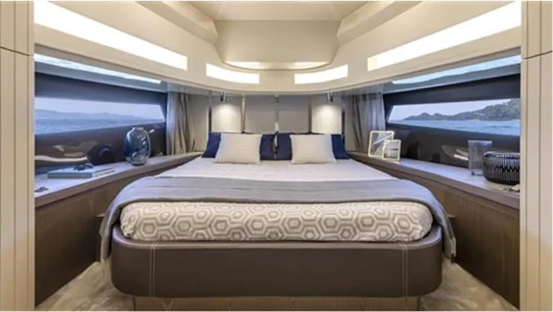  Yacht Photos Pics Luxurious bedroom interior of 2021 Invictus TT460 yacht with panoramic windows and elegant decor.