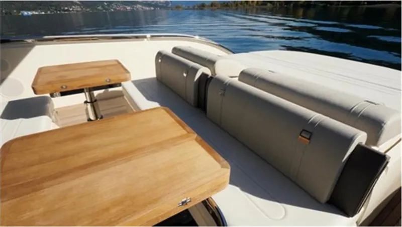  Yacht Photos Pics Invictus TT460 2021 yacht interior with wooden tables and cushioned seating.