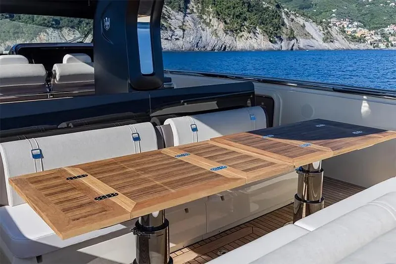  Yacht Photos Pics Luxury yacht Invictus TT460 2021 with elegant wooden table and scenic ocean view.
