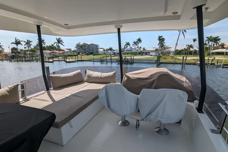 Fly Girl Yacht Photos Pics 2020 Fountaine Pajot MY 37 yacht deck with seating, overlooking a serene waterfront view.
