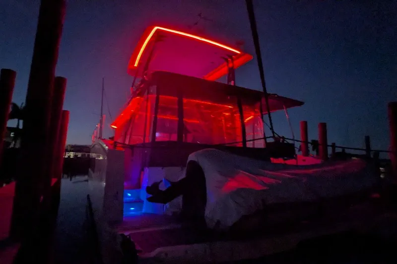 Fly Girl Yacht Photos Pics 2020 Fountaine Pajot MY 37 yacht illuminated with vibrant red and blue lights at night.