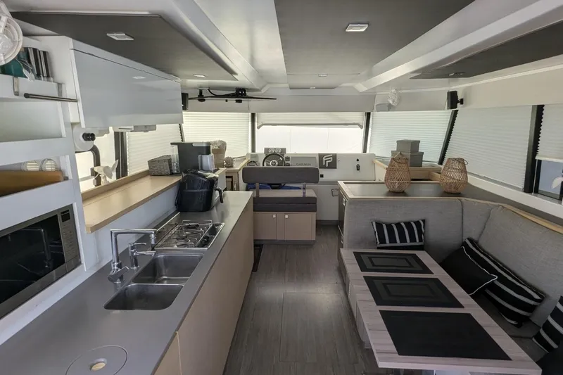 Fly Girl Yacht Photos Pics Modern interior of 2020 Fountaine Pajot MY 37 yacht with kitchen and seating area.