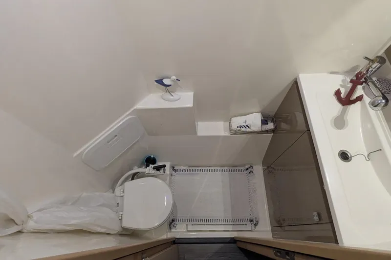 Fly Girl Yacht Photos Pics Bathroom interior of 2020 Fountaine Pajot MY 37 yacht, featuring toilet and sink.