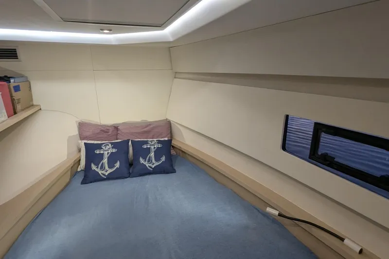 Fly Girl Yacht Photos Pics Cozy cabin interior of 2020 Fountaine Pajot MY 37 with nautical-themed pillows.