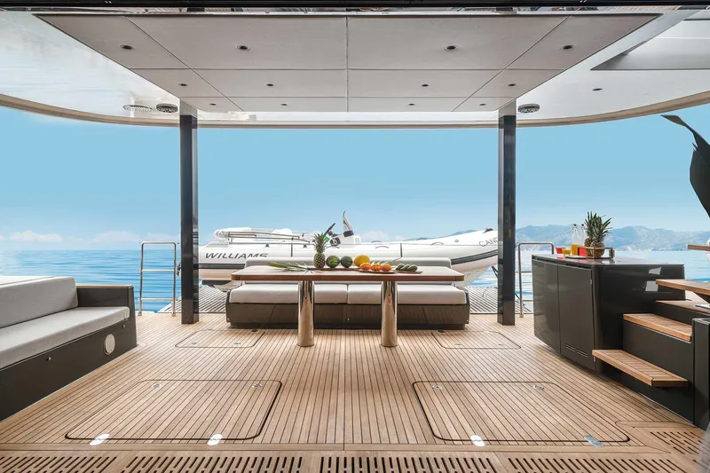 Candy Yacht Photos Pics Luxurious Sunreef 70 yacht deck with modern seating, table, and scenic ocean view.