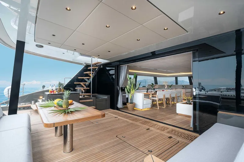 Candy Yacht Photos Pics Luxurious Sunreef 70 yacht interior with elegant dining area and ocean view, 2021 model.