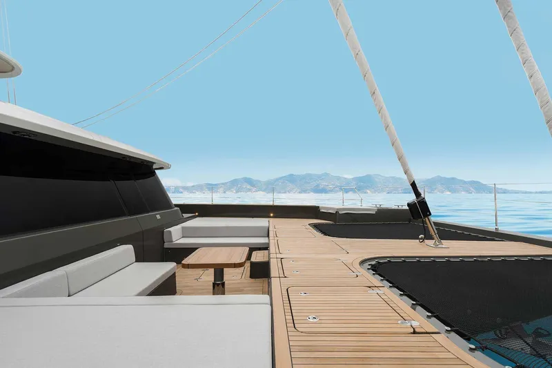Candy Yacht Photos Pics Luxurious Sunreef 70 yacht deck with seating, 2021 model, against a serene ocean backdrop.
