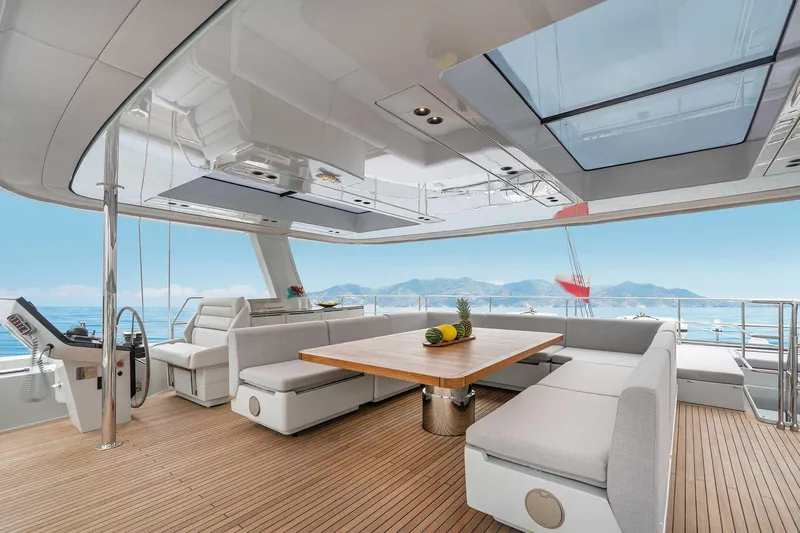 Candy Yacht Photos Pics Luxurious Sunreef 70 yacht interior with elegant seating and ocean view, 2021 model.