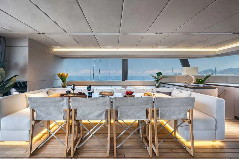 Candy Yacht Photos Pics Luxurious Sunreef 70 yacht interior, 2021 model, featuring elegant dining area with ocean view.