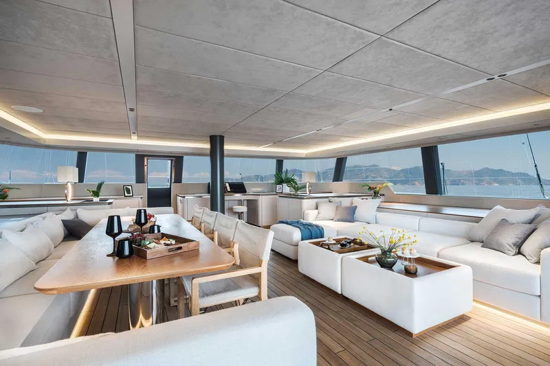 Candy Yacht Photos Pics Luxurious Sunreef 70 yacht interior, 2021 model, featuring elegant seating and panoramic windows.
