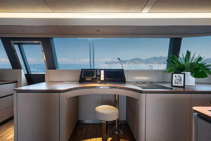 Candy Yacht Photos Pics Luxurious interior of 2021 Sunreef 70 yacht with panoramic ocean view and modern decor.