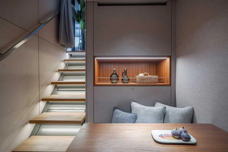 Candy Yacht Photos Pics Modern interior of 2021 Sunreef 70 yacht with elegant staircase and cozy seating area.