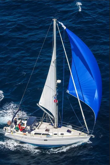 Alcyone Yacht Photos Pics Sailing yacht Catalina 350 (2007) with blue spinnaker on open sea.