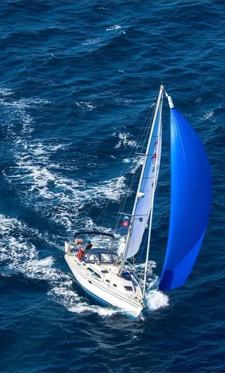 Alcyone Yacht Photos Pics Sailboat Catalina 350 (2007) navigating with blue spinnaker on open sea.