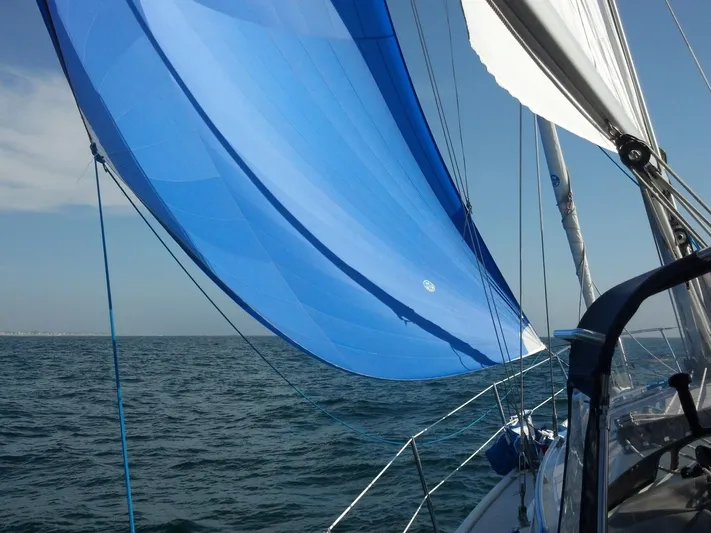 Alcyone Yacht Photos Pics Sailing on a 2007 Catalina 350 with vibrant blue spinnaker over open sea.