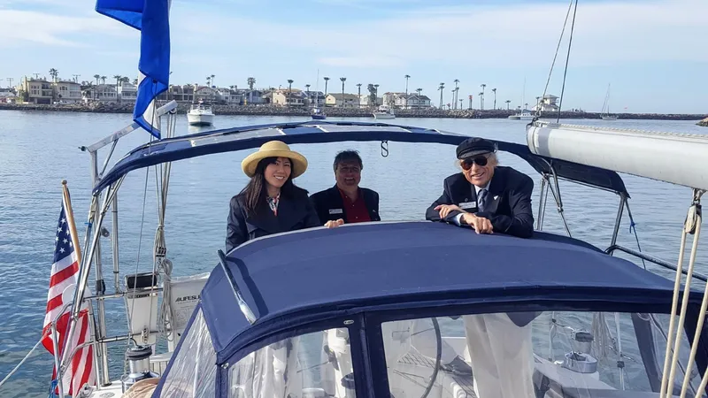 Alcyone Yacht Photos Pics Three people enjoying a day on a 2007 Catalina 350 sailboat in a marina.