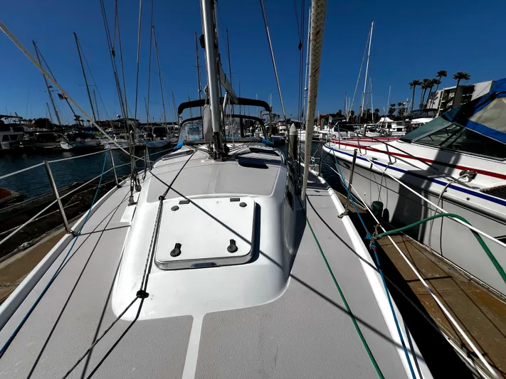 Alcyone Yacht Photos Pics Sailboat deck view of 2007 Catalina 350 docked in marina under clear blue sky.