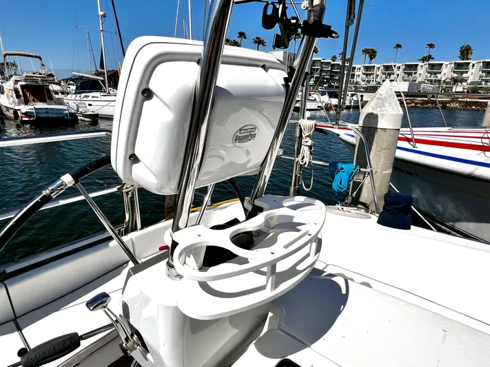 Alcyone Yacht Photos Pics Cockpit of 2007 Catalina 350 sailboat docked in marina, featuring steering wheel and navigation equipment.