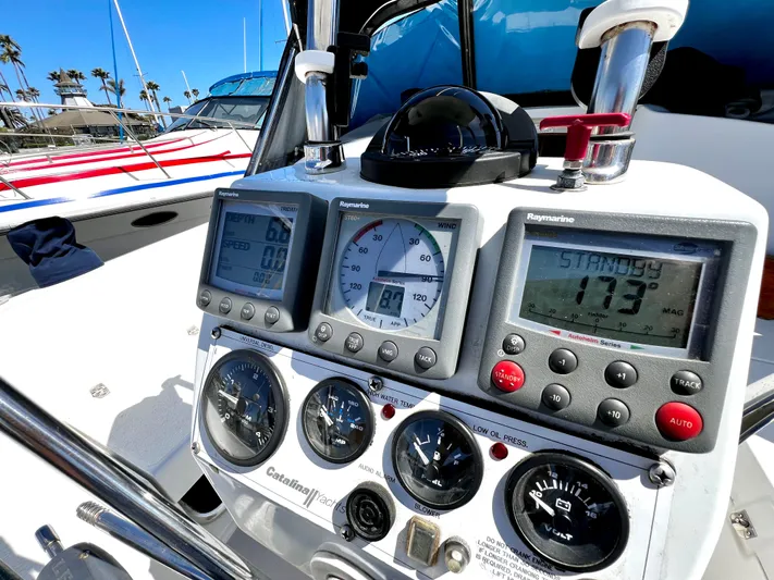 Alcyone Yacht Photos Pics Control panel of a 2007 Catalina 350 sailboat with navigation instruments and gauges.