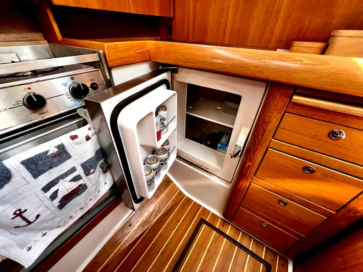 Alcyone Yacht Photos Pics Galley of 2007 Catalina 350 yacht with fridge, stove, and wooden cabinetry.