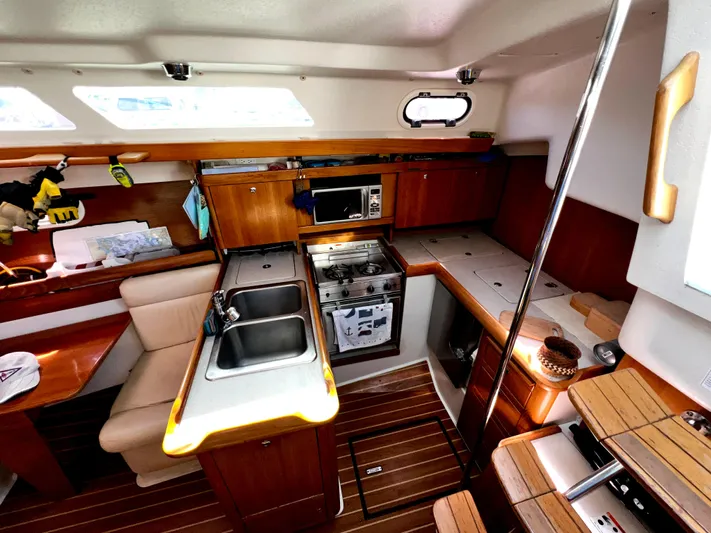 Alcyone Yacht Photos Pics Interior of 2007 Catalina 350 sailboat kitchen with wood finish and modern appliances.