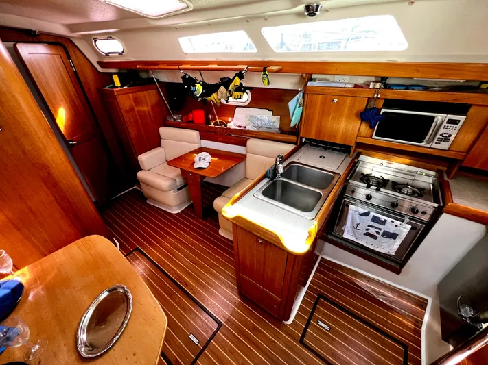 Alcyone Yacht Photos Pics Interior of 2007 Catalina 350 sailboat with kitchen and dining area.