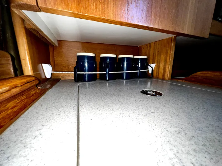 Alcyone Yacht Photos Pics Wooden interior of a 2007 Catalina 350 yacht with spice jars on a countertop.