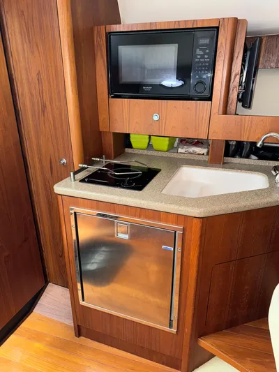  Yacht Photos Pics 2012 Tiara Yachts 3100 Open galley with microwave, stove, sink, and fridge.