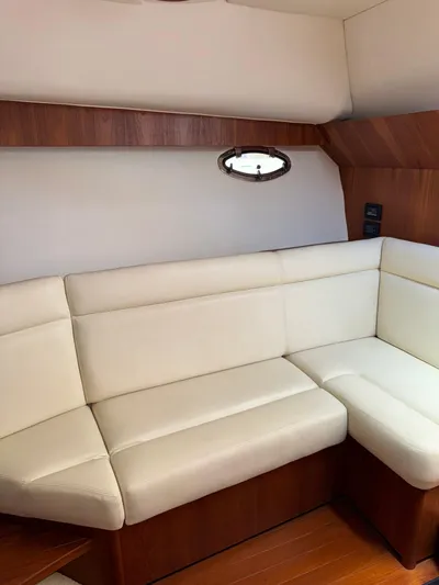  Yacht Photos Pics 2012 Tiara Yachts 3100 Open interior with white leather seating and wooden accents.