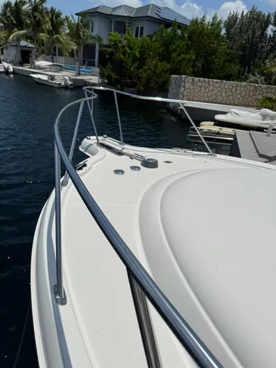 Yacht Photos Pics 2012 Tiara Yachts 3100 Open docked near waterfront home.