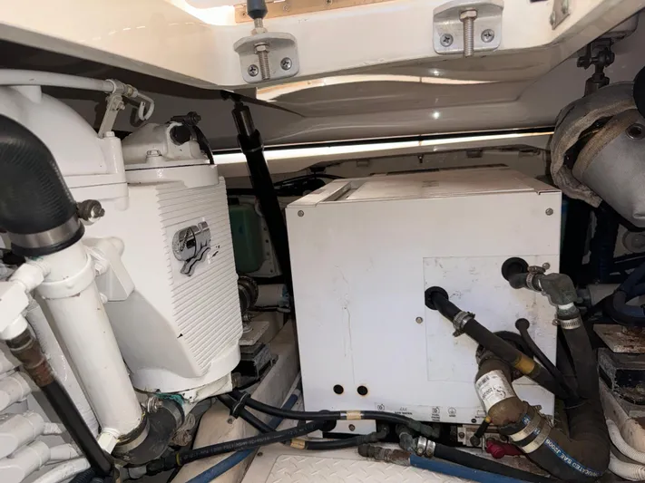  Yacht Photos Pics Engine compartment of 2012 Tiara Yachts 3100 Open, showcasing mechanical components and piping.
