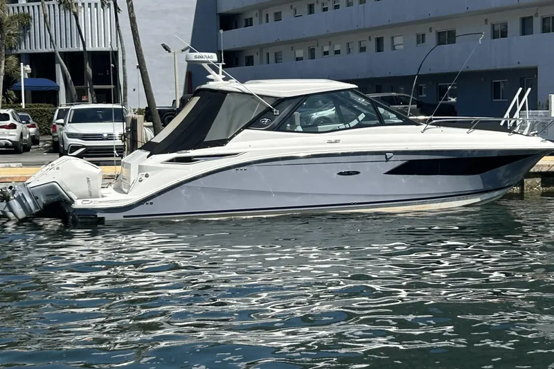  Yacht Photos Pics 2023 Sea Ray 320 DA OB boat docked in marina, reflecting on water.