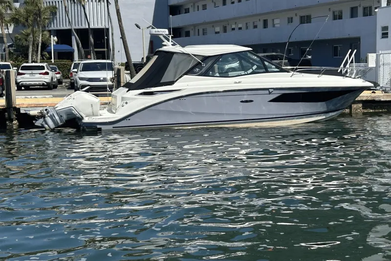  Yacht Photos Pics 2023 Sea Ray 320 DA OB boat docked in marina, reflecting on water.