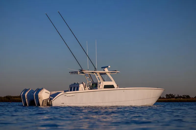  Yacht Photos Pics 2026 Invincible 38 Catamaran on calm water at sunset.