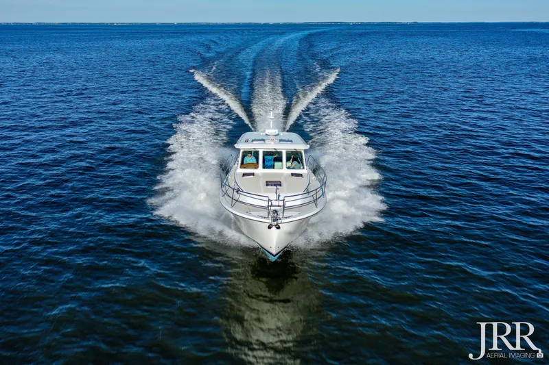 Serendipity Yacht Photos Pics 2019 Sabre 38 Salon Express cruising on open water, aerial view.