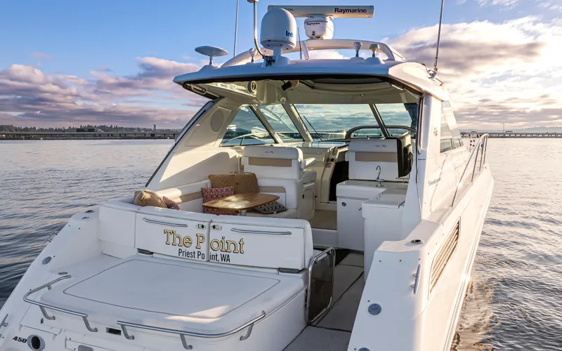  Yacht Photos Pics 2010 Sea Ray Sundancer yacht on calm water at sunset.