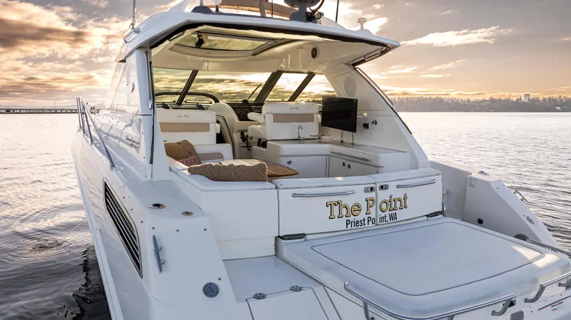  Yacht Photos Pics Luxury 2010 Sea Ray Sundancer yacht on serene water at sunset.