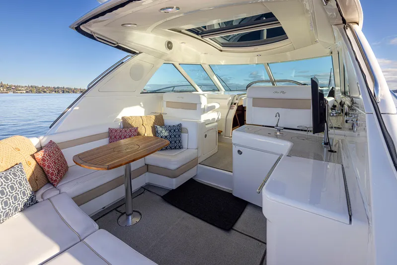  Yacht Photos Pics Luxurious 2010 Sea Ray Sundancer yacht interior with seating, table, and scenic water view.