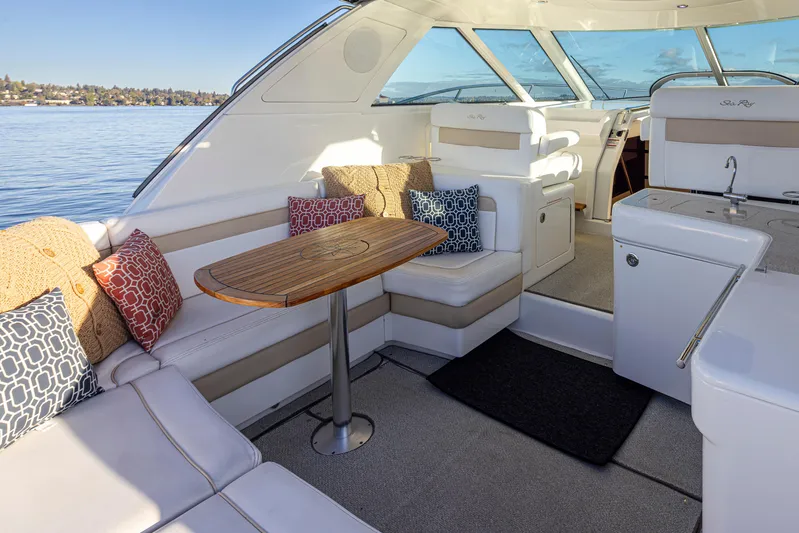  Yacht Photos Pics Luxurious 2010 Sea Ray Sundancer interior with plush seating and elegant wooden table.