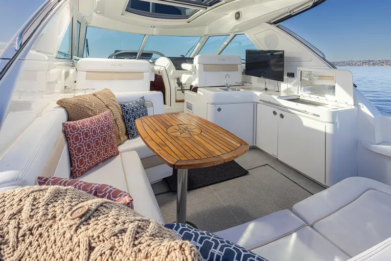  Yacht Photos Pics Luxurious 2010 Sea Ray Sundancer yacht interior with plush seating and elegant wooden table.