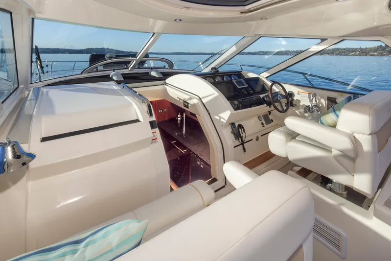  Yacht Photos Pics Luxurious 2010 Sea Ray Sundancer yacht interior with helm, plush seating, and scenic water view.