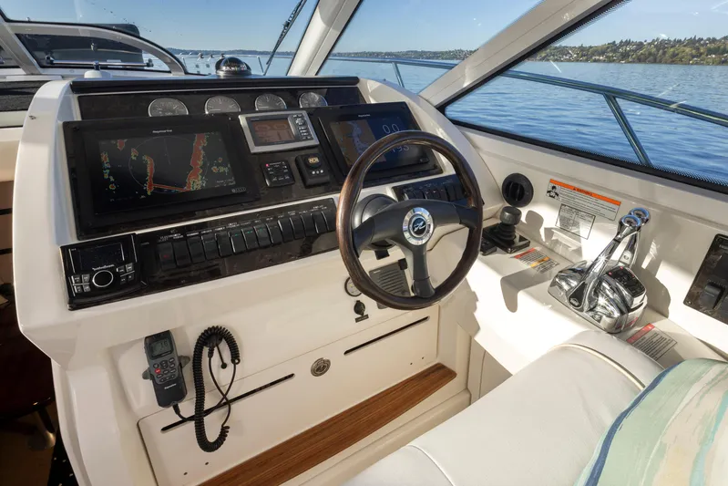  Yacht Photos Pics 2010 Sea Ray Sundancer helm with navigation screens and controls on a sunny day.