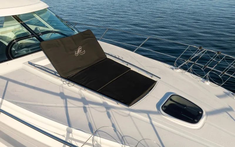  Yacht Photos Pics 2010 Sea Ray Sundancer yacht deck with sunpad, on calm water.