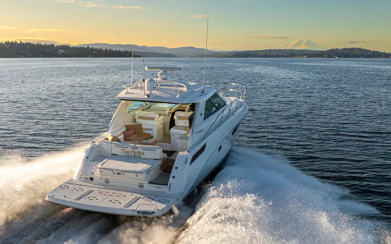  Yacht Photos Pics 2010 Sea Ray Sundancer yacht cruising on a scenic lake at sunset.